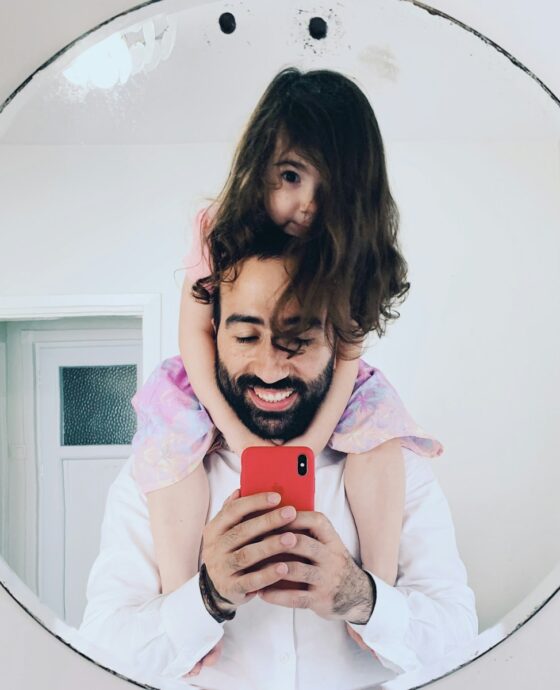 girl in white long sleeve shirt holding red iphone 5 c