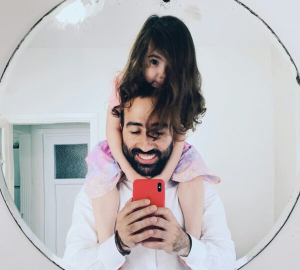 girl in white long sleeve shirt holding red iphone 5 c