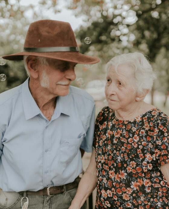 an older man and an older woman standing next to each other
