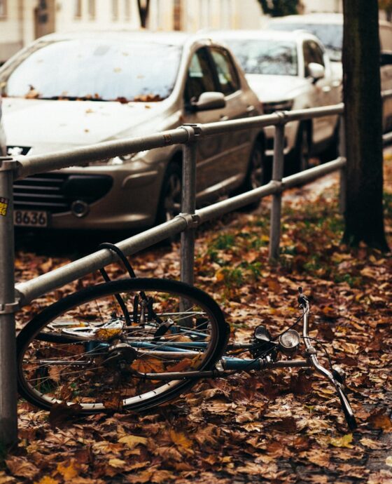 a bicycle leaning against a fence