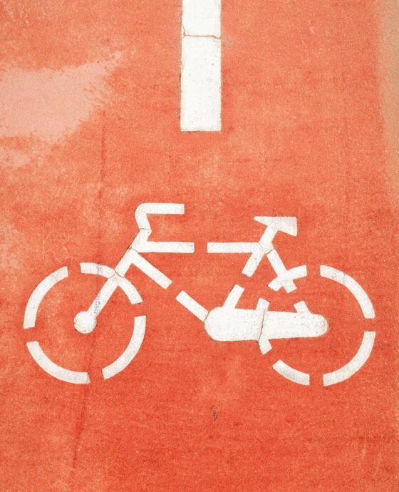 a bicycle sign painted on the side of a building