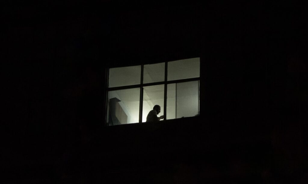 a person standing in a window at night