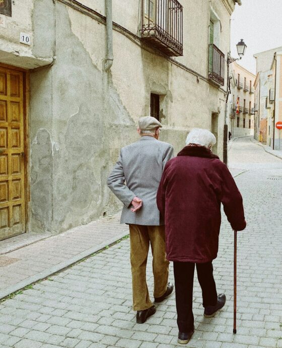 man and woman walking near closed wooden door