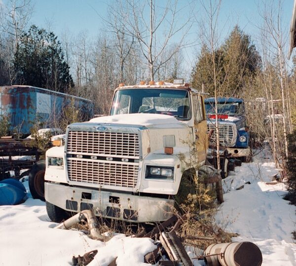 white truck on snow covered ground during daytime