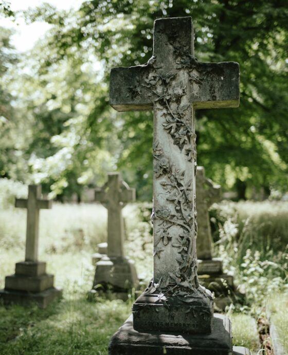 a cemetery with a cross in the middle of it