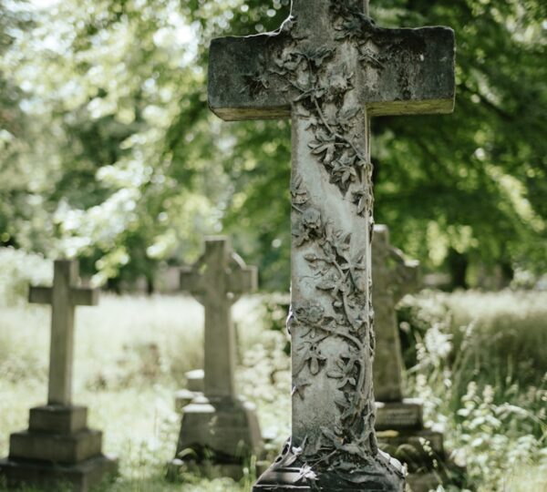 a cemetery with a cross in the middle of it