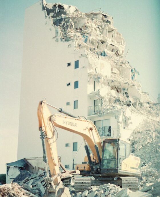 a large white building with a large pile of snow on the ground
