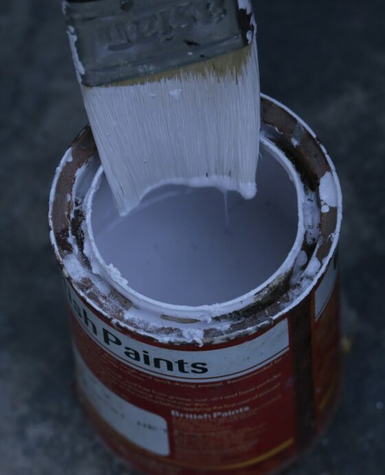 a paint can with a brush inside of it