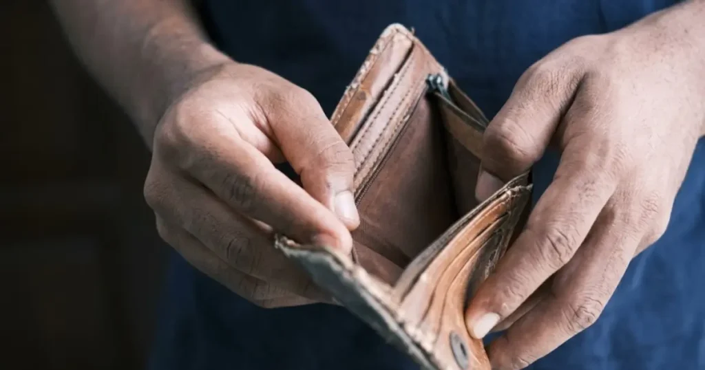 A Man holding an empty wallet | Financial Deprivation | Coercive Control